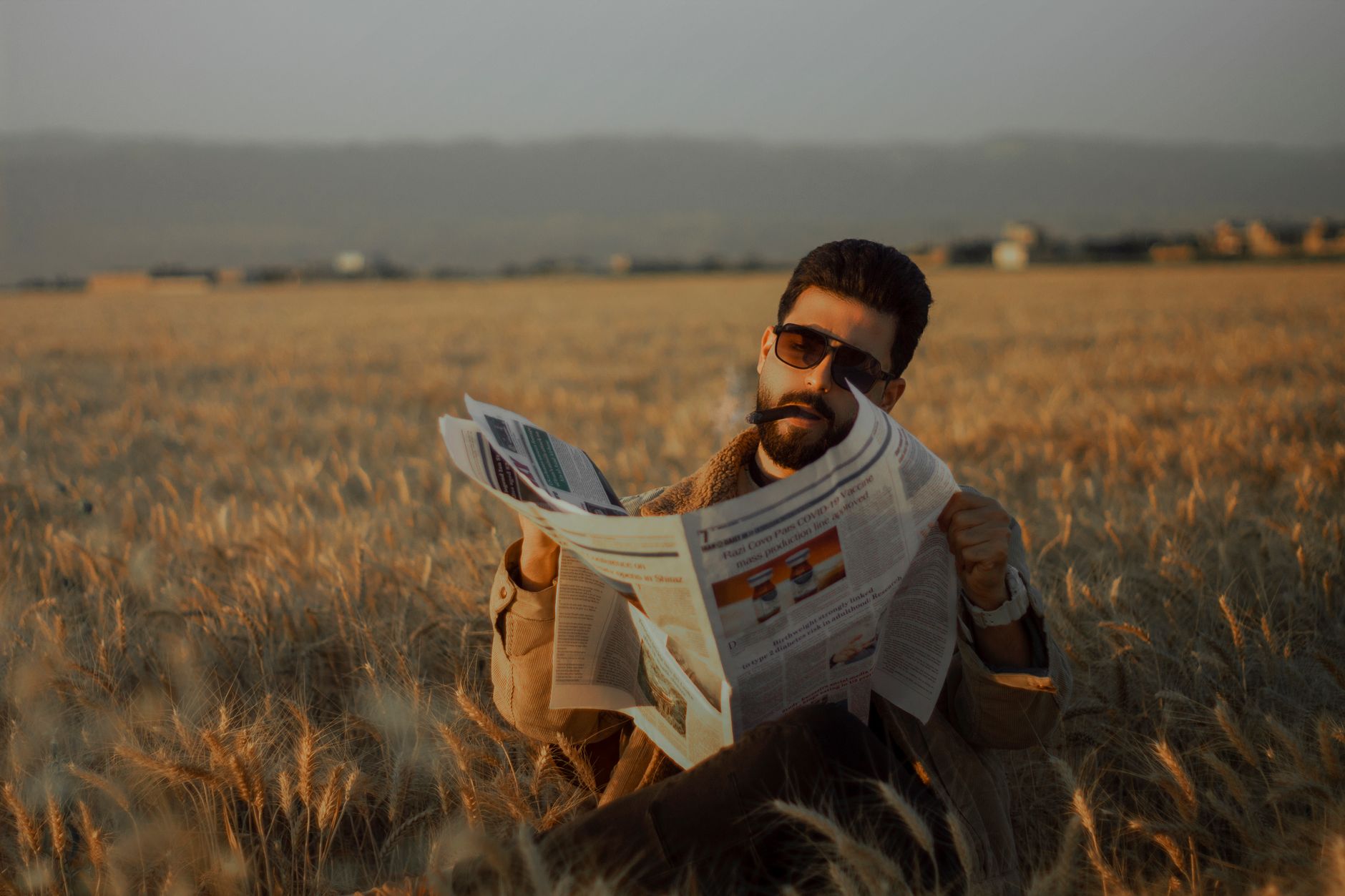 Middle-aged man sitting in a serene wheat field, reading a newspaper during the day. — Wie viele Spiele bietet Chicken Road C